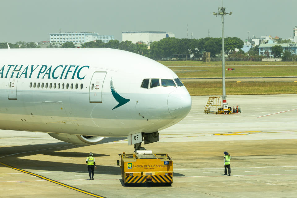 Ho Chi Minh City, Vietnam - ‎‎February 8, 2020 : An Airplane Of Cathay Pacific Boeing 777-300ER Moved To Taxiway By Pushback Tractor In Tan Son Nhat International Airport (SGN-VVTS).