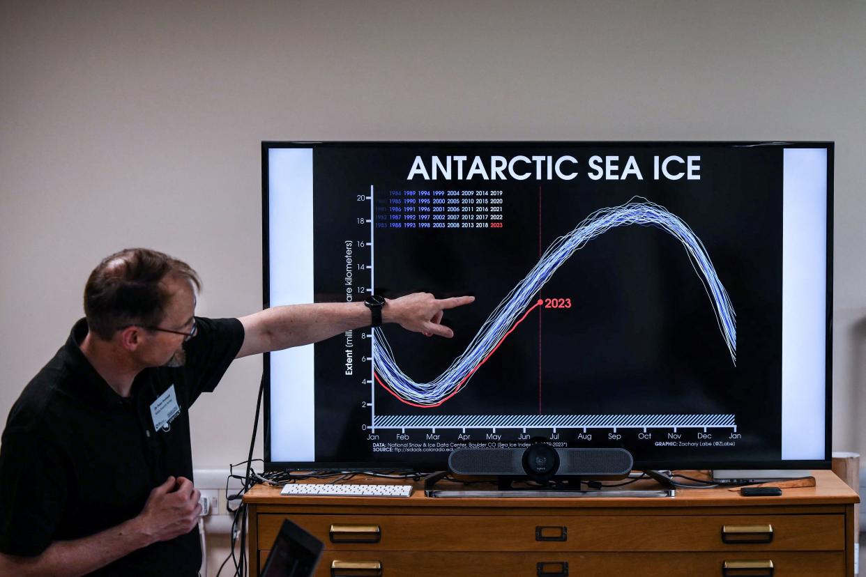 A Professor of the British Antarctic Survey explains a graph on the situation of the Anatartic sea ice at different years during a visit of the British Antarctic Survey's headquarters in Cambridge, on June 19, 2023 for the launch of the new 10-year BAS science strategy Polar region of Polar Science for a Sustainable Planet. With research stations transferring to renewable energy and artificial intelligence mapping out fuel-efficient marine routes, the British Antarctic Survey is putting sustainability at the heart of its new 10-year plan. At the BAS headquarters in Cambridge, eastern England, AFP saw some of the cutting-edge technology used by scientists studying the polar regions. (Photo by Daniel LEAL / AFP) (Photo by DANIEL LEAL/AFP via Getty Images)