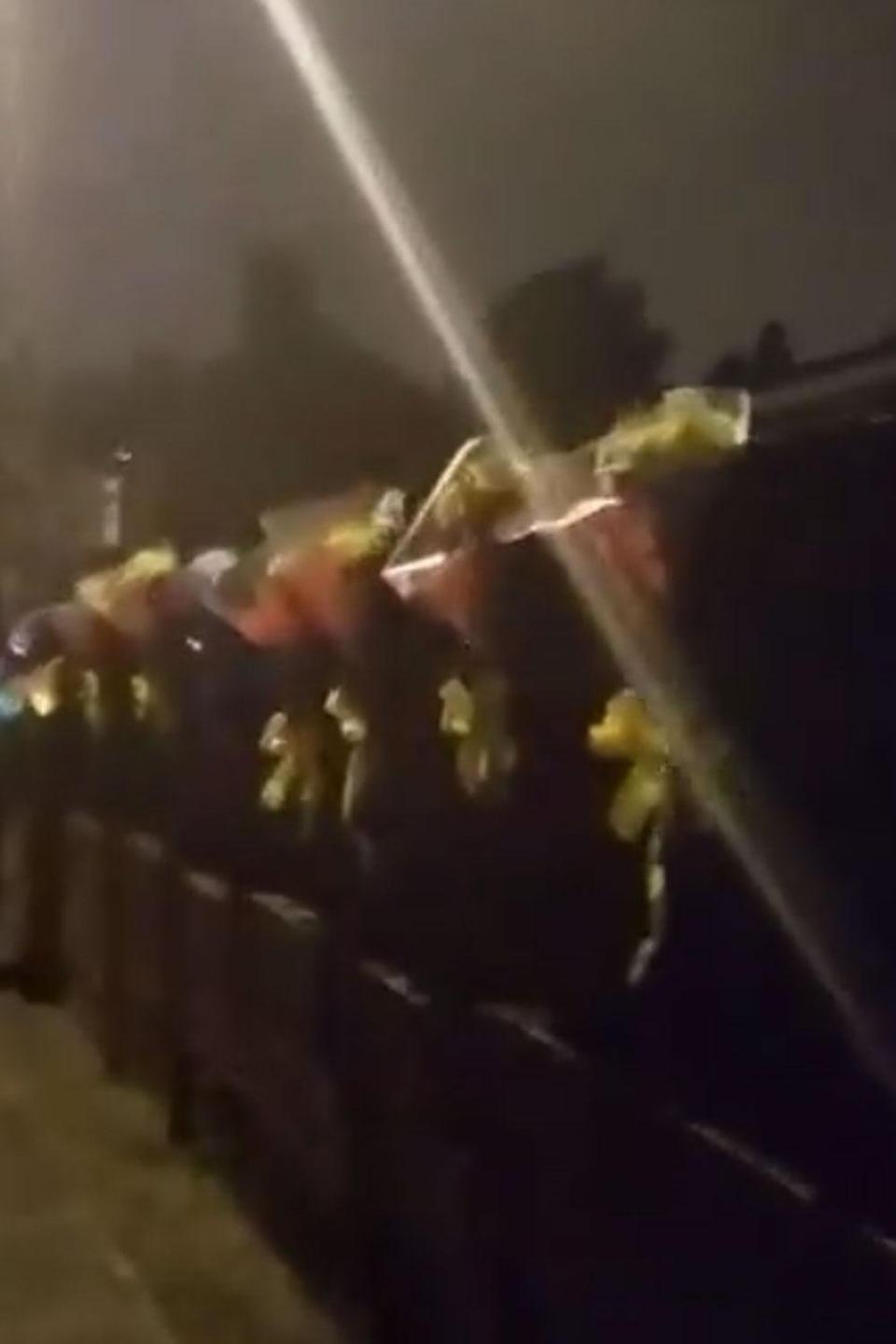 The video shows the man angrily tearing the flowers off the fence