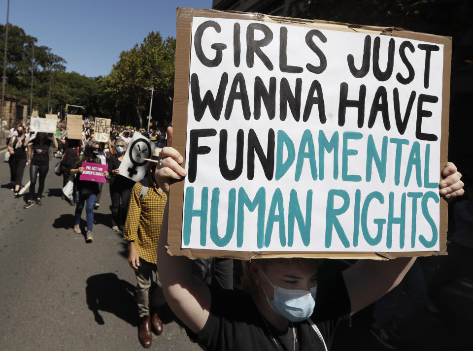 Thousands of people with placards and banners rally demanding justice for women in Sydney, Monday, March 15, 2021, as the government reels from two separate allegations. The rally was one of several across Australia including in Canberra, Melbourne, Brisbane and Hobart calling out sexism, misogyny and dangerous workplace cultures. (AP Photo/Rick Rycroft)