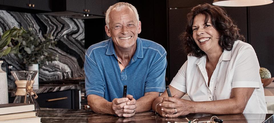 A mature man and woman holding Juul e-cigs