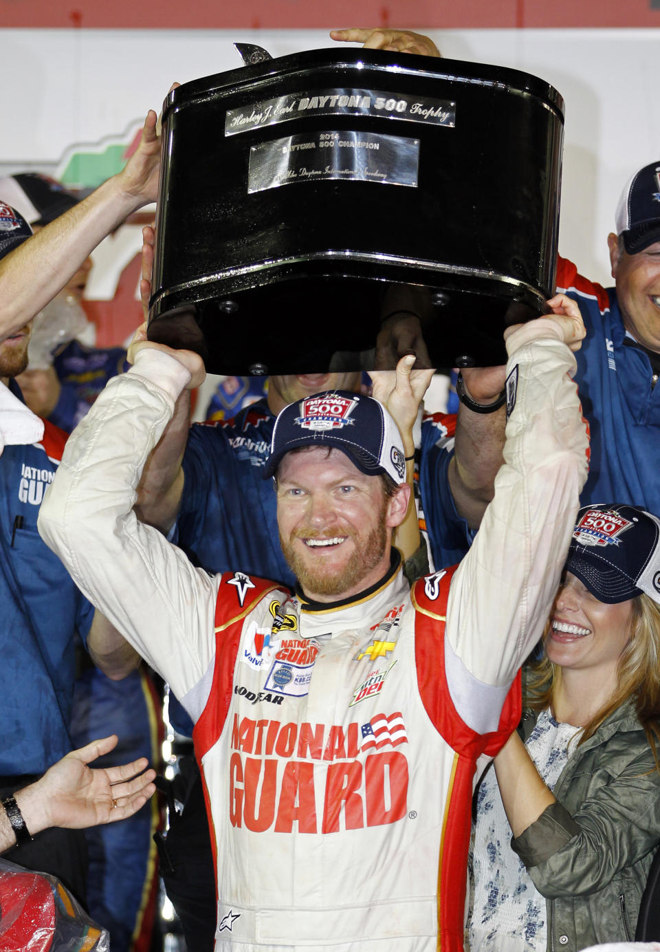 Dale Earnhardt Jr. raises the trophy in Victory Lane after winning the NASCAR Daytona 500 Sprint Cup series auto race at Daytona International Speedway in Daytona Beach, Fla., Sunday, Feb. 23, 2014. (AP Photo/Terry Renna)