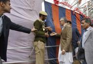 Kashmir's Chief Minister Omar Abdullah (in brown coat) prepares to shake hands with his supporters through a temporary tent after an election campaign by Kashmir's ruling National Conference (NC) party in Qazigund, south of Srinagar April 16, 2014. REUTERS/Danish Ismail