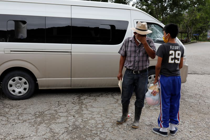 Juan reacts while sharing a moment with his disabled 12-year-old son Gustavo, who was expelled by U.S. authorities to Guatemala under an emergency health order, during their reunion in Peten