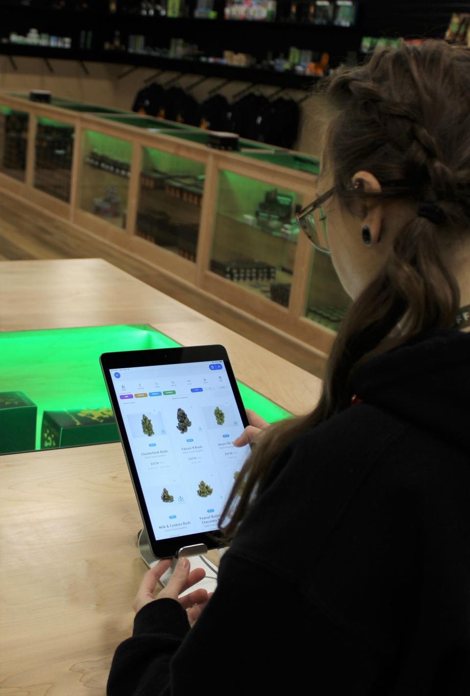 Hilary “Hilly” Donbrosky, a bud-tender at Green Labs Provisions, accesses one of the store’s computers available for customers to search product information.