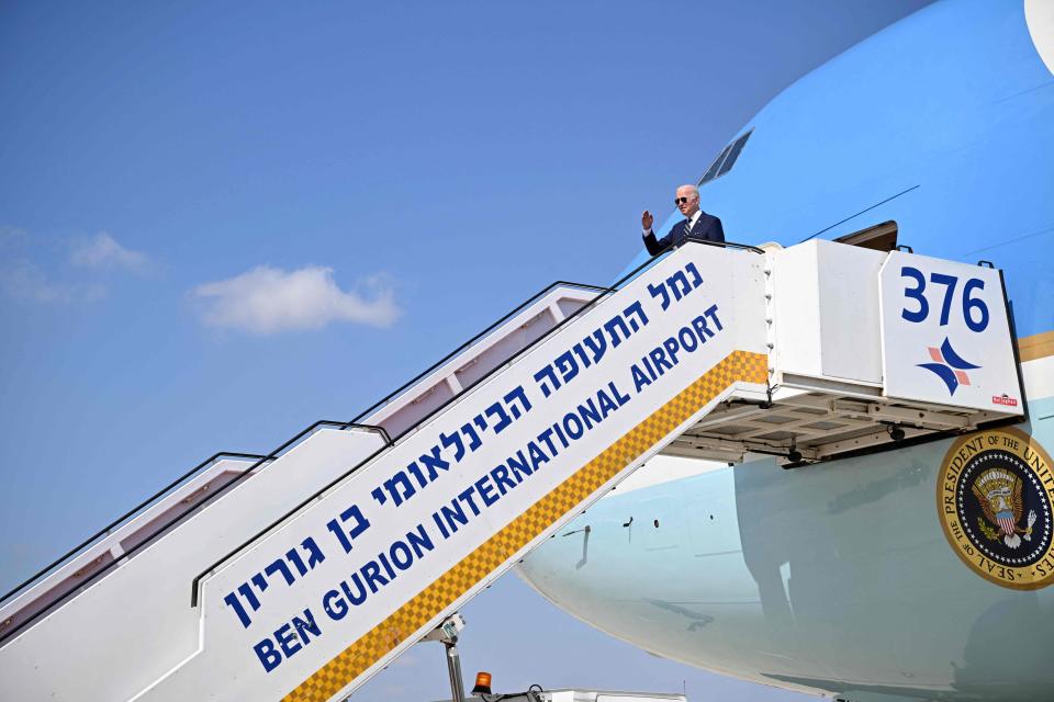 Joe Biden gives a salute before boarding Air Force One to depart Israel’s Ben Gurion Airport on 15 July 2022 (AFP via Getty Images)