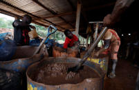 A young artisanal miner washes crushed rock containing gold in metal drums at the unlicensed mining site of Nsuaem Top in Ghana, November 23, 2018. REUTERS/Zohra Bensemra