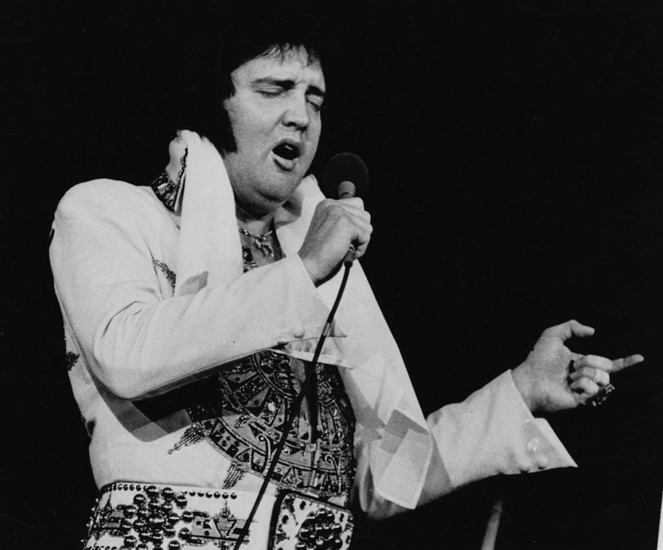 ** FILE ** Elvis Presley is shown performing in Providence, R.I., in this May 23, 1977, file photo. In observance of the 25th anniversary of Presley's death, the Cumberland County Civic Center in Portland, Maine, will present a two-hour musical tribute, ``The Concert That Never Happened,'' on Aug. 17, 2002, featuring Elvis impersonator Jack Smink. Presley, who died Aug. 16, 1977, was scheduled to perform at the Civic Center Aug. 17 and Aug. 18, 1977.  (AP Photo/File)NY8