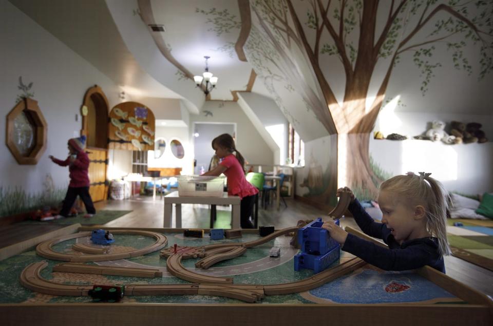 Kids play at Fable Child Care Centre in Morinville, Alta. It's a fantastical structure with a wavy roof, curved wooden doors and - as Chauvet's story goes - a chimney squashed by a giant.