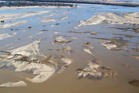 FILE PHOTO: Flooded farm fields seen from Nebraska Army National Guard CH-47 Chinook helicopter to deliver multiple bales of hay to cattle isolated by historic flooding in Nebraska