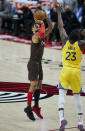 Portland Trail Blazers guard Gary Trent Jr., left, shoots a 3-point basket over Golden State Warriors forward Draymond Green during the second half of an NBA basketball game in Portland, Ore., Wednesday, March 3, 2021. (AP Photo/Craig Mitchelldyer)