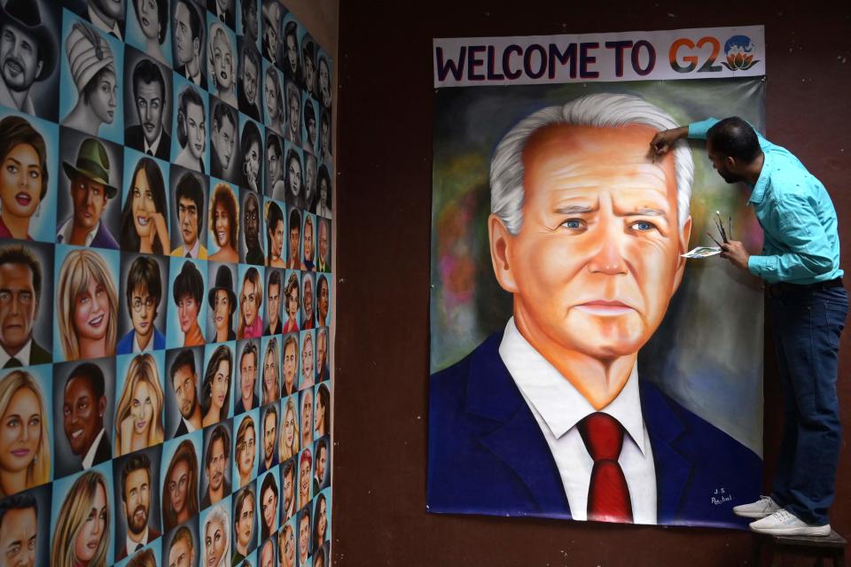 Indian artist Jagjot Singh Rubal gives final touches to an oil painting of President Joe Biden, at his workshop in Amritsar on Sept. 5, 2023, ahead of the two-day G20 summit in New Delhi.