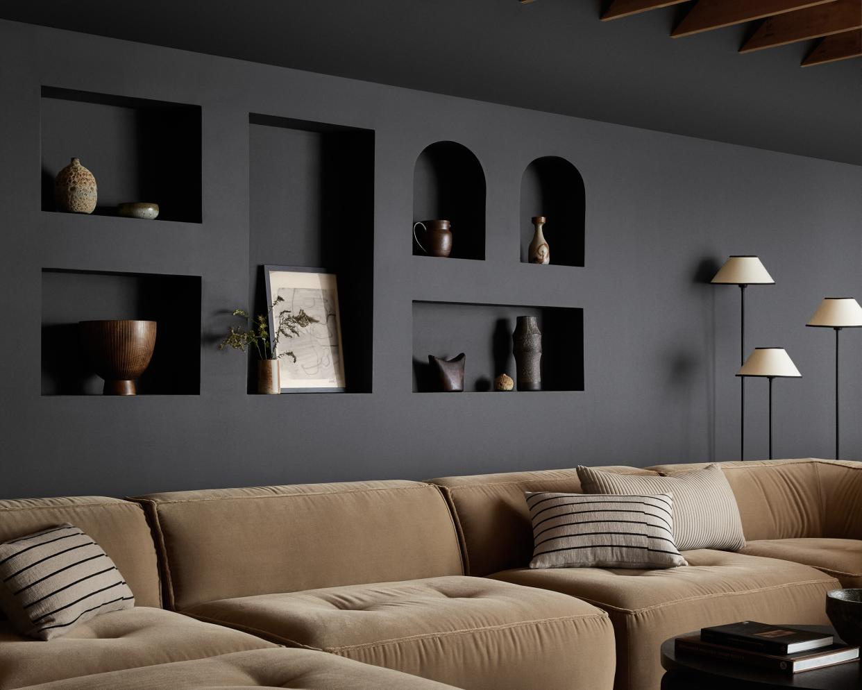  A black living room wall with niches. 