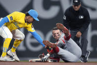 Los Angeles Angels' Zach Neto, right, hangs on to second base on his double, while Boston Red Sox shortstop David Hamilton applies a late tag during the fourth inning of a baseball game Friday, April 12, 2024, in Boston. (AP Photo/Charles Krupa)