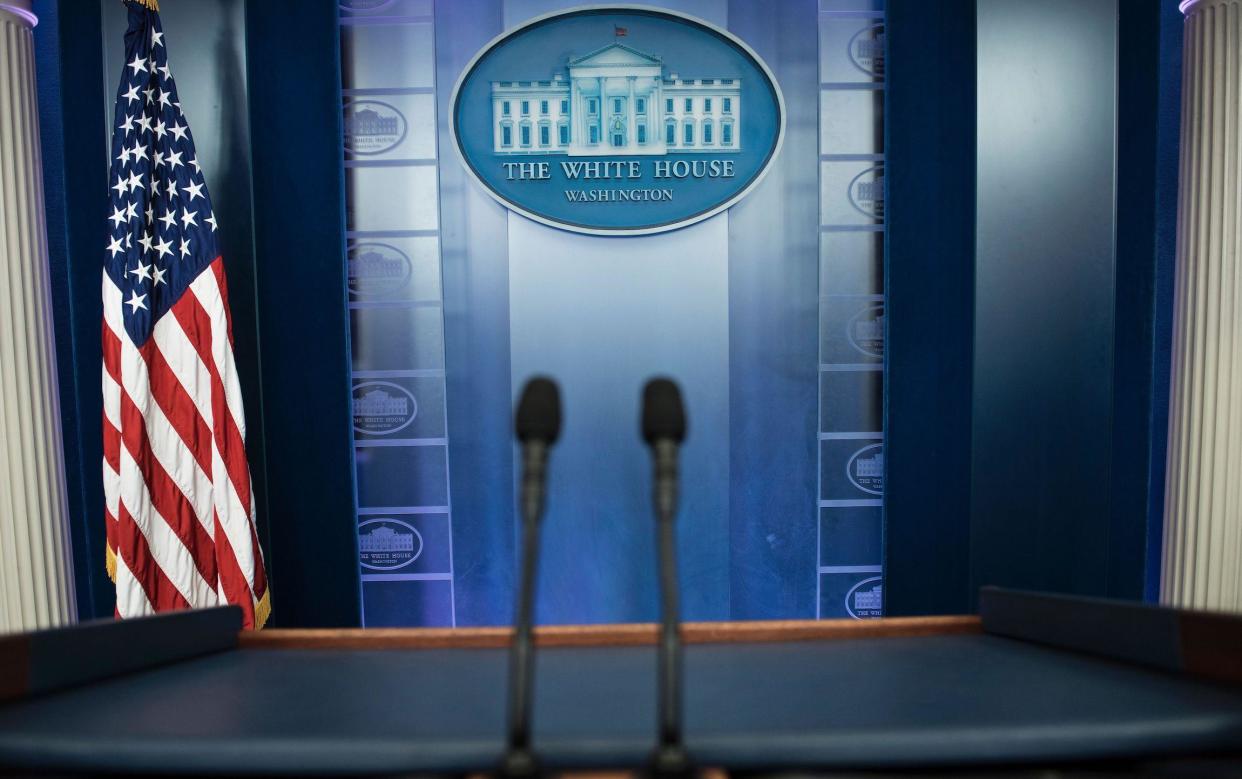 An empty podium is seen as an off camera briefing is held with a group of reporters in Washington DC on February 24, 2017: Brendan Smialowski/AFP/Getty