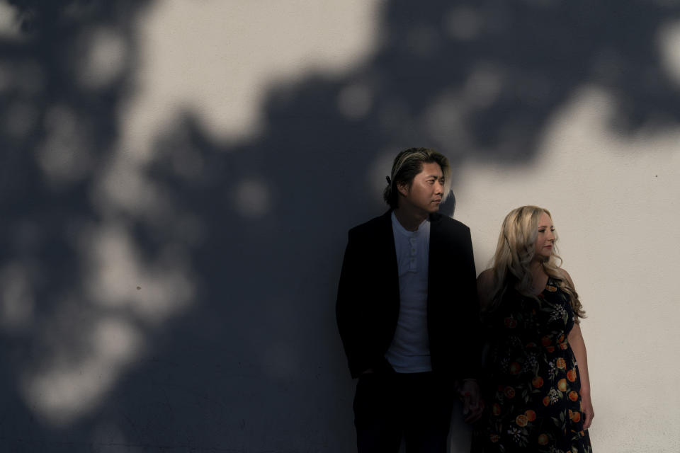 Jessica Tincopa and her husband, Rob Tran, stand for a portrait in Orange, Calif., Friday, May 5, 2023. Tincopa may leave the photography business she spent 14 years building for one reason: to find coverage for fertility treatment. After six miscarriages, Tincopa and her husband started saving for in vitro fertilization, which can cost well over $20,000, but the pandemic wiped out their savings and the state's health insurance marketplace doesn't cover things like IVF. (AP Photo/Jae C. Hong)