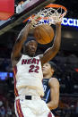 Miami Heat forward Jimmy Butler (22) dunks over Orlando Magic guard R.J. Hampton during the first half of an NBA basketball game, Sunday, Dec. 26, 2021, in Miami. (AP Photo/Lynne Sladky)