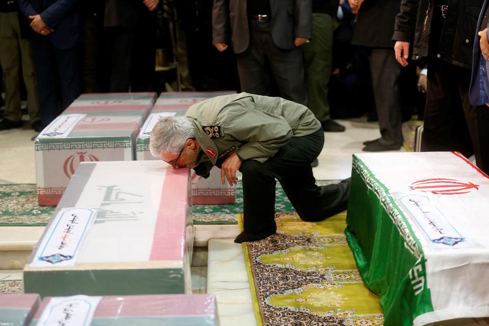 TEHRAN, IRAN - JANUARY 06: (----EDITORIAL USE ONLY  MANDATORY CREDIT - "IRANIAN LEADER PRESS OFFICE / HANDOUT" - NO MARKETING NO ADVERTISING CAMPAIGNS - DISTRIBUTED AS A SERVICE TO CLIENTS----) Soleimanis long-time lieutenant and the new leader of Quds Force Gen. Esmail Qaani mourns over the coffin of Abu Mahdi al-Muhandis, vice president of Hashd al-Shaabi group, during the funeral ceremony, in Tehran, Iran on January 06, 2019.  (Photo by Iranian Leader Press Office / Handout/Anadolu Agency via Getty Images)