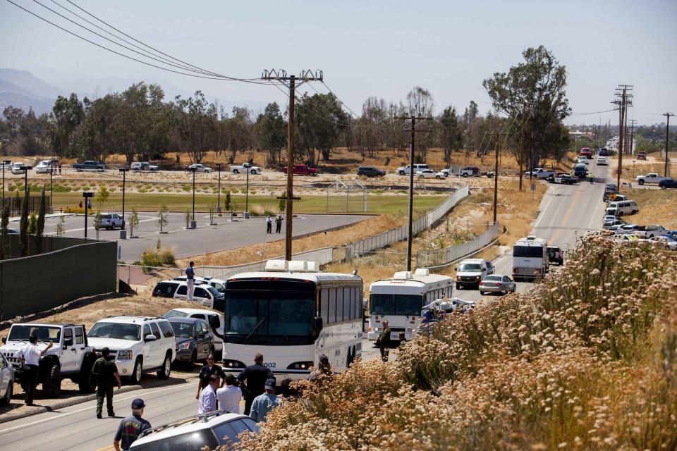 Buses packed with undocumented migrants who were scheduled to be processed at the Murrieta Border Patrol Station retreat up the road after being stopped in their tracks by demonstrators in Murrieta, California July 1, 2014. (REUTERS/Sam Hodgson)