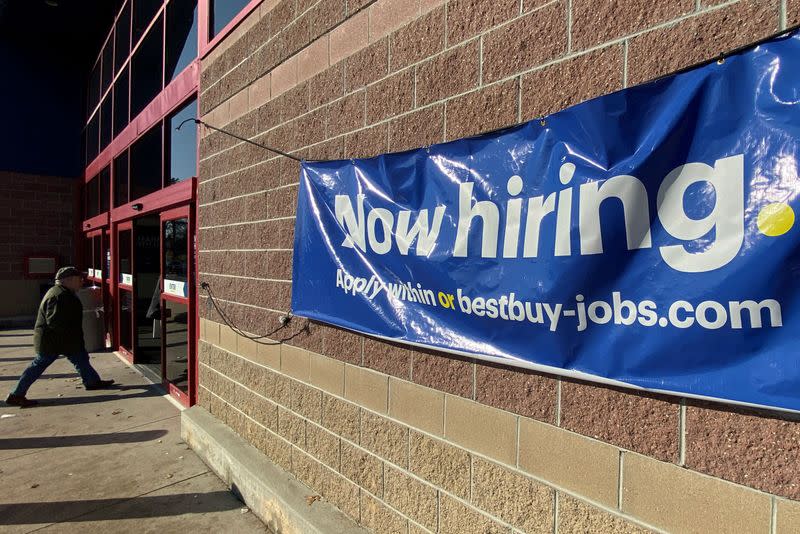 FILE PHOTO: A "Now Hiring" sign advertising jobs at Best Buy hangs outside a store in Salem