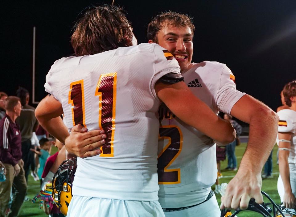 Bloomington North receiver Jack Leonard (11) celebrates with quarterback Dash King (2) after defeating Bloomington South, 25-24, in overtime at South on Friday, September 8, 2023.