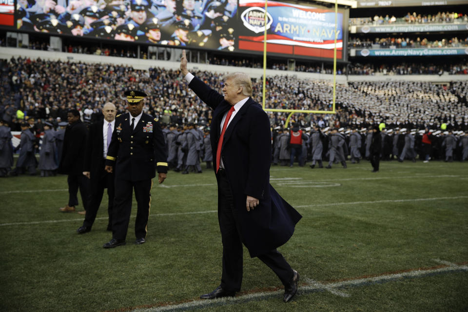 President Donald Trump waves to attendees ahead of an NCAA college football between Army and Navy, Saturday, Dec. 8, 2018, in Philadelphia. (AP Photo/Matt Rourke)