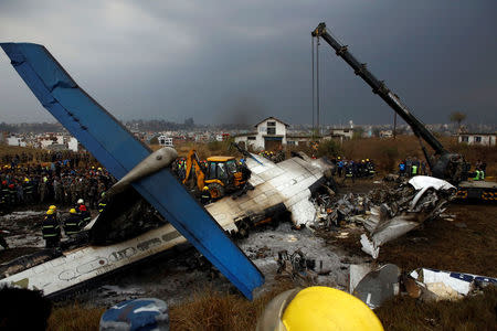 Rescue workers work at the wreckage of a US-Bangla airplane after it crashed at the Tribhuvan International Airport in Kathmandu, Nepal March 12, 2018. REUTERS/ Navesh Chitrakar