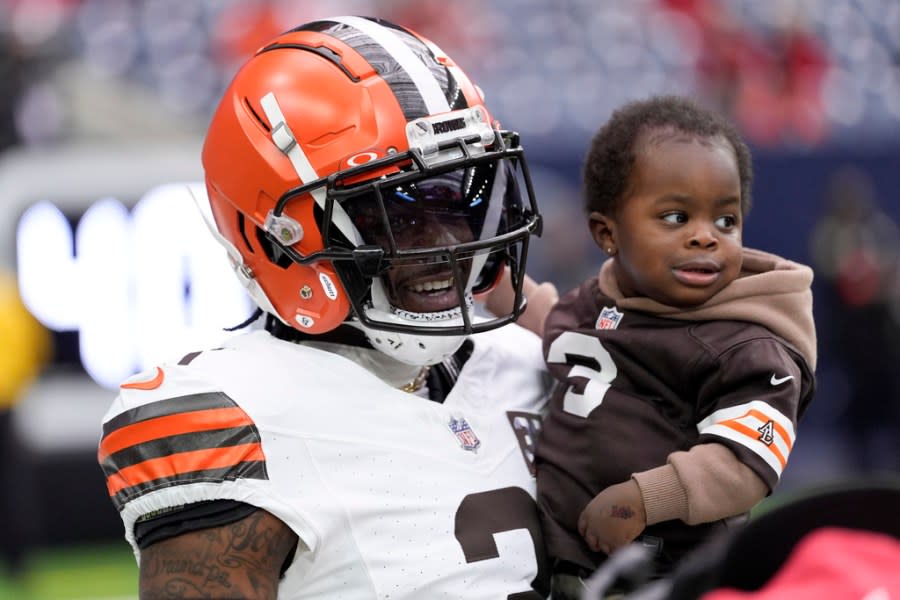 Cleveland Browns wide receiver Marquise Goodwin plays with his son before an NFL wild-card playoff football game between the Houston Texans and the Cleveland Browns Saturday, Jan. 13, 2024, in Houston. (AP Photo/David J. Phillip)