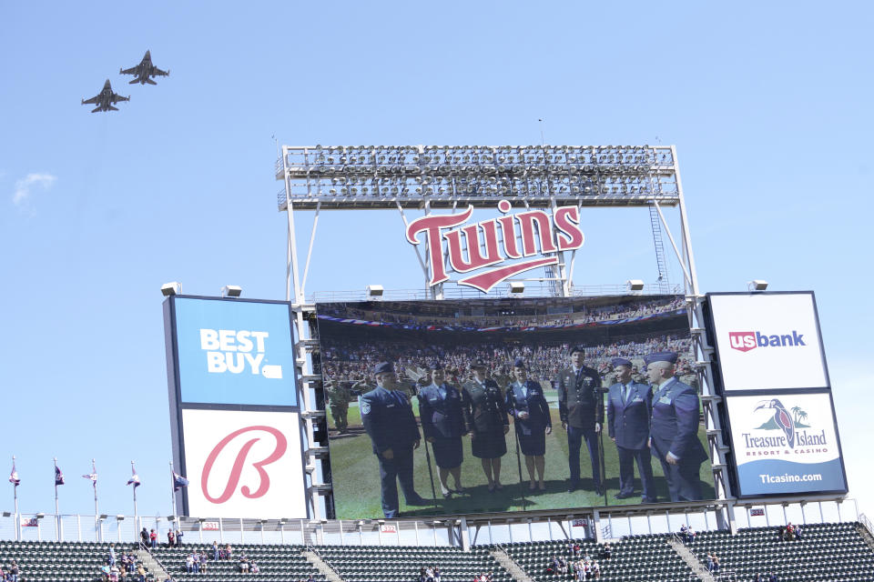 Two F16 fighter planes fly over Target field at the end of the national anthem as the Minnesota Twins marked Armed Forces Appreciation Day and remembrance of 9/11 prior to a baseball game against the Cleveland Guardians, Sunday, Sept 11, 2022, in Minneapolis. (AP Photo/Jim Mone)