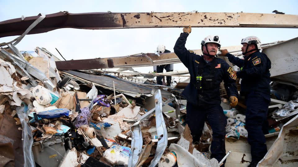 Search and rescue teams look for survivors in a former Dollar General after a tornado in Matador, Texas, on June 22, 2023. - Annie Rice/Lubbock Avalanche-Journal/AP