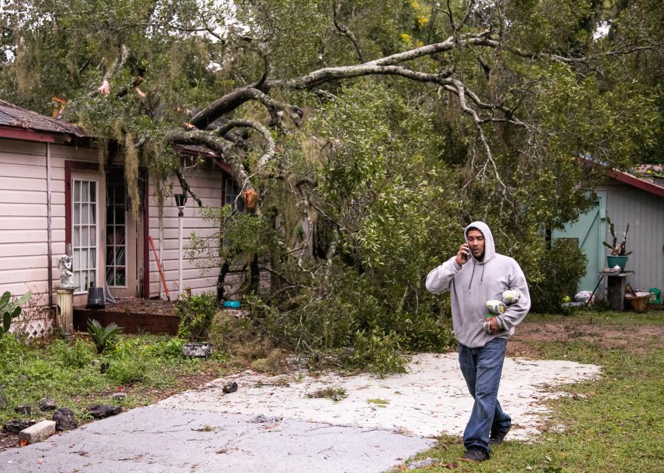 Jose Gonzales walks by the home of his landlord at 1613 NW Third Ave., Ocala, on Thursday morning while carrying some frozen food. "The tree fell on the home around 9:30-10 p.m. last night," Gonzales said. Hurricane Ian passed through Marion County overnight, bringing high wind and rain. "I had to climb through the window to get Willie out. He's 72. He's OK." No one was injured at the home, according to Gonzales.