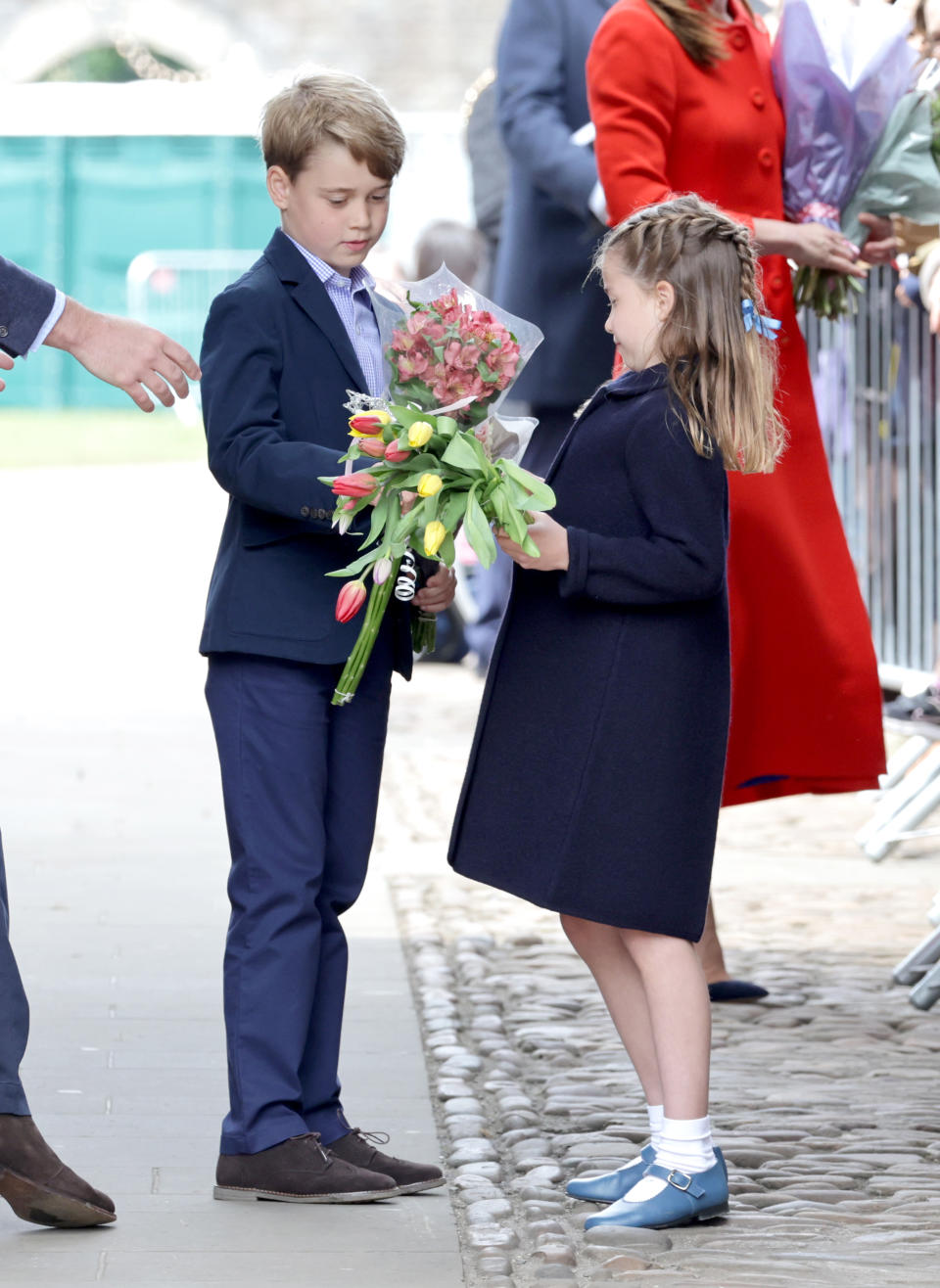 CARDIFF, WALES - JUNE 04: Prince George of Cambridge and Princess Charlotte of Cambridge hold gifts of flowers during a visit to Cardiff Castle on June 04, 2022 in Cardiff, Wales. The Platinum Jubilee of Elizabeth II is being celebrated from June 2 to June 5, 2022, in the UK and Commonwealth to mark the 70th anniversary of the accession of Queen Elizabeth II on 6 February 1952.  (Photo by Chris Jackson/Getty Images)