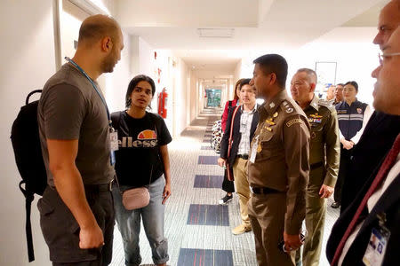 Saudi teen Rahaf Mohammed al-Qunun is greeted by Thai immigration authorities at a hotel inside Suvarnabhumi Airport in Bangkok, Thailand January 7, 2019. Thailand Immigration Police via REUTERS