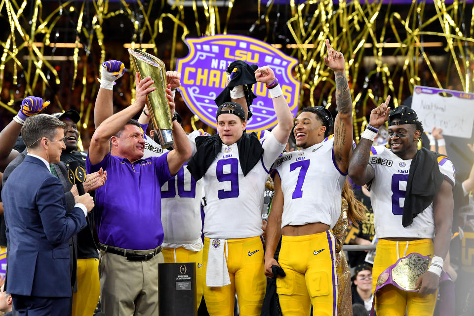 NEW ORLEANS, LOUISIANA - JANUARY 13: Head coach Ed Orgeron of the LSU Tigers raises the National Championship Trophy with Joe Burrow #9, Grant Delpit #7, and Patrick Queen #8 after the College Football Playoff National Championship game at the Mercedes Benz Superdome on January 13, 2020 in New Orleans, Louisiana. The LSU Tigers topped the Clemson Tigers, 42-25. (Photo by Alika Jenner/Getty Images)