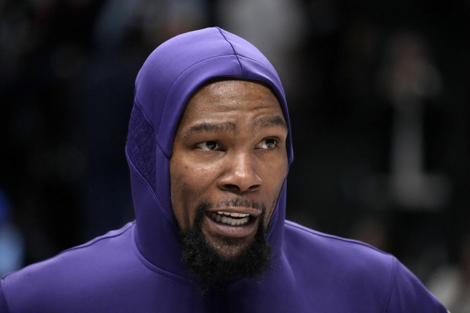 Phoenix Suns forward Kevin Durant responds to question during an on-court interview after the team's NBA basketball game against the Dallas Mavericks in Dallas, Wednesday, Jan. 24, 2024. (AP Photo/Tony Gutierrez)