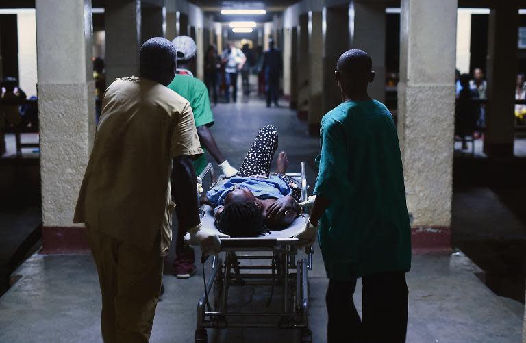 A woman is treated at hospital in Burundi's capital Bujumbura on May 22, 2015 after a double grenade attack by unknown assailants on a market in the city centre that killed three people