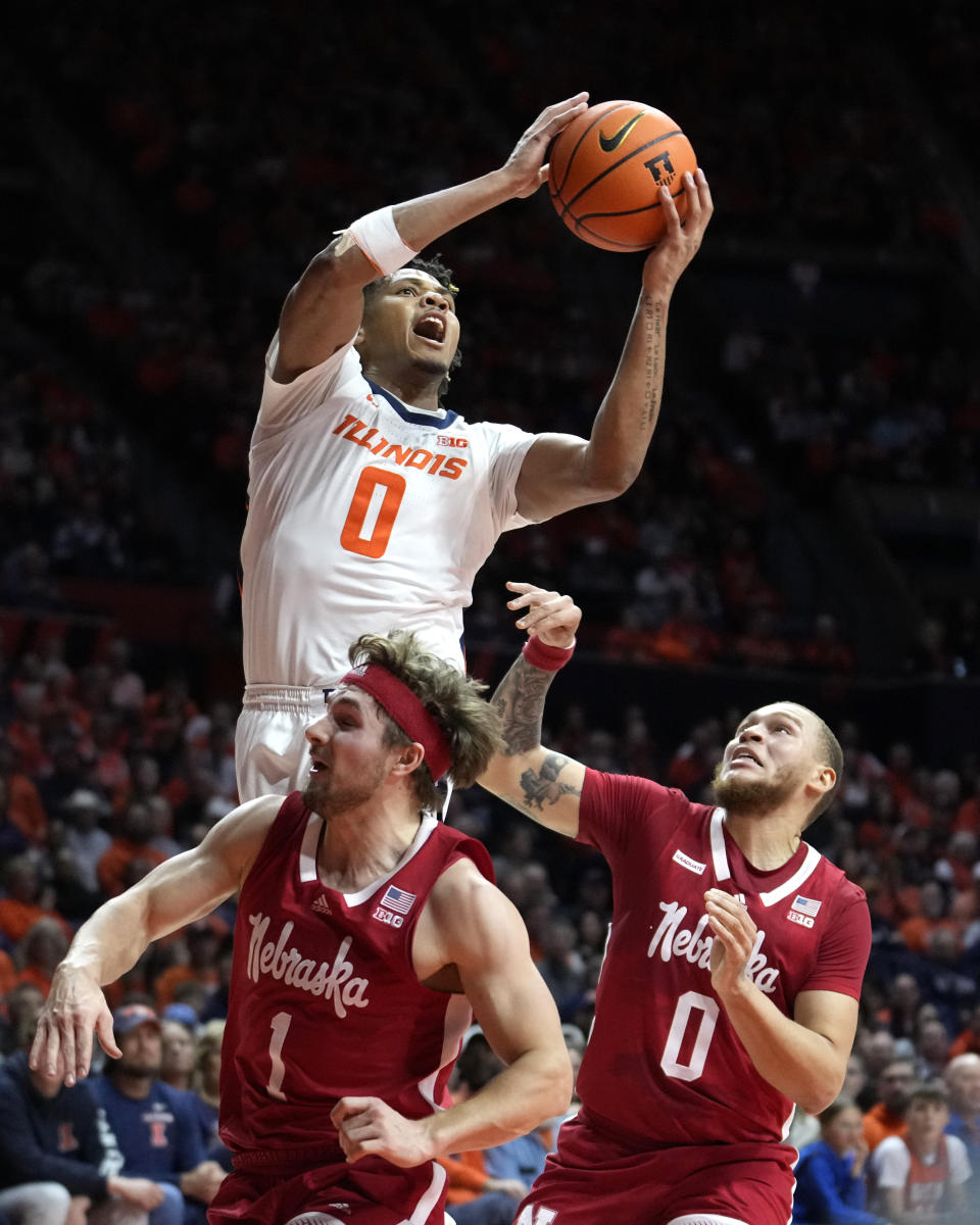 FILE - Illinois' Terrence Shannon Jr. (0) drives to the basket as Nebraska's Sam Hoiberg (1) and C.J. Wilcher defend during the first half of an NCAA college basketball game Sunday, Feb. 4, 2024, in Champaign, Ill. Shannon Jr. was selected to the AP All-Big Ten first team in voting released Tuesday, March 12, 2024.(AP Photo/Charles Rex Arbogast, File)