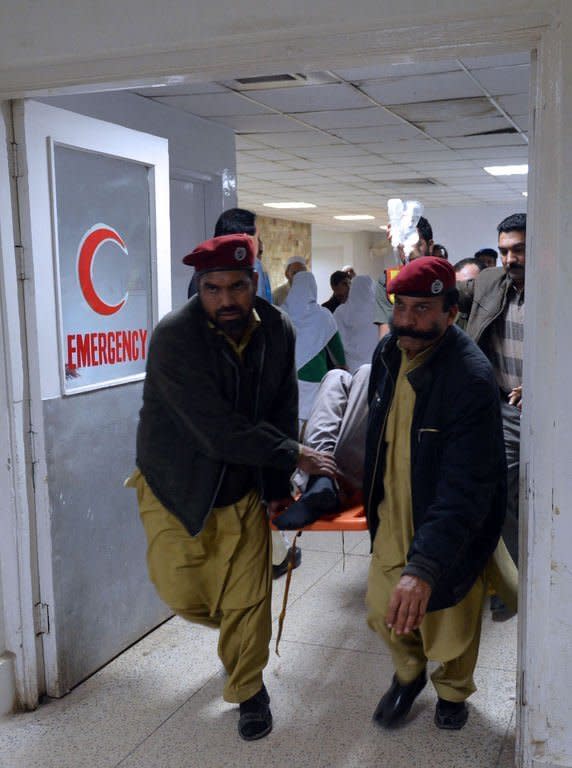 Medics help a victim injured during a rocket attack at Peshawar airport on December 15, 2012. Two rockets landed inside the airport in Peshawar, the main gateway to the semi-autonomous tribal belt on the Afghan border, officials say