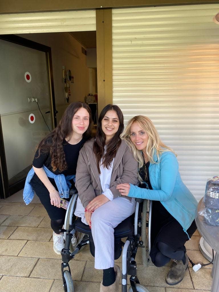 Dinie Scheiner (right), with her daughter Malka (left), pose with Gali Segal, who lost her right leg while hiding in a bomb shelter during the Hamas attack on the Supernova music festival Oct. 7. Segal's fiance, Ben Binyamin, also lost his right leg in the attack.