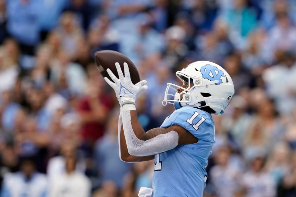 North Carolina wide receiver Josh Downs (11) catches a touchdown pass against Florida State during the first half of their game in Chapel Hill Oct. 9, 2021.
