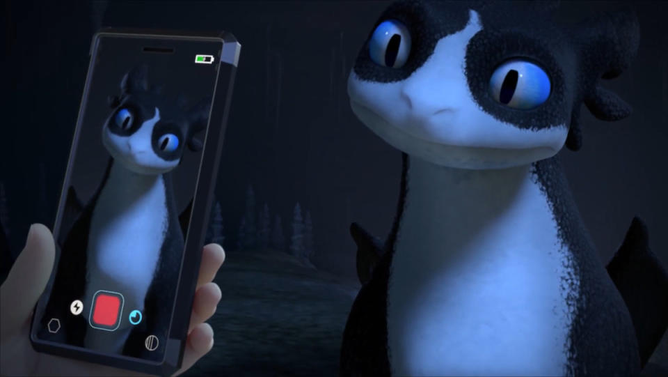 Tom looks at Thunder, the new dragon from Dreamworks' Dragons: The Nine Realms, through a phone in a new clip from this How To Train Your Dragon show.