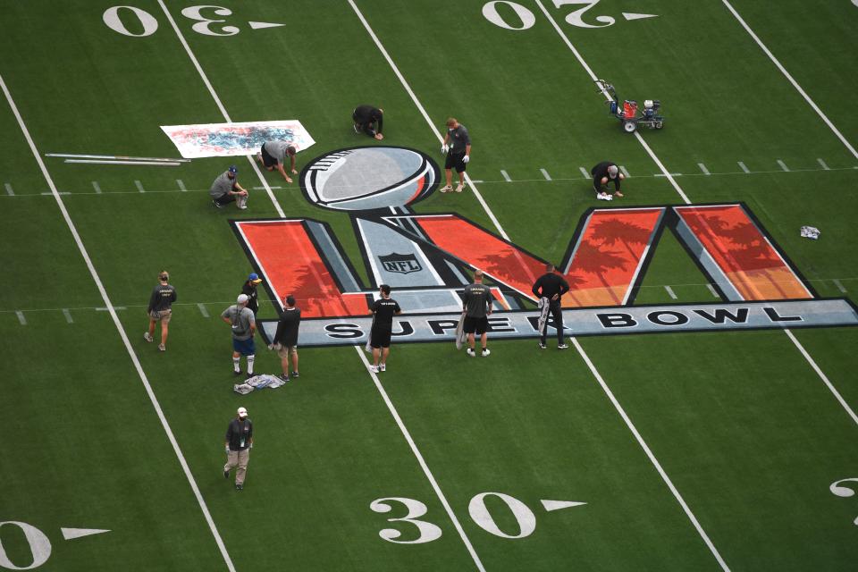 Workers prepare the field one day before Super Bowl LVI between the Los Angeles Rams and the Cincinatti Bengals at So-Fi Stadium in Inglewood, California on February 12, 2022. (Photo by VALERIE MACON / AFP) (Photo by VALERIE MACON/AFP via Getty Images)