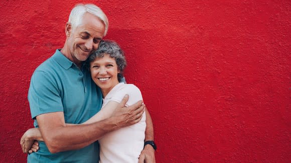 An older couple hugging.