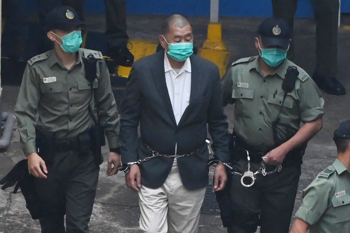 Hong Kong pro-democracy media tycoon Jimmy Lai is led into a police van as he heads to court to be charged under the territory’s controversial new national security law (AFP via Getty Images)