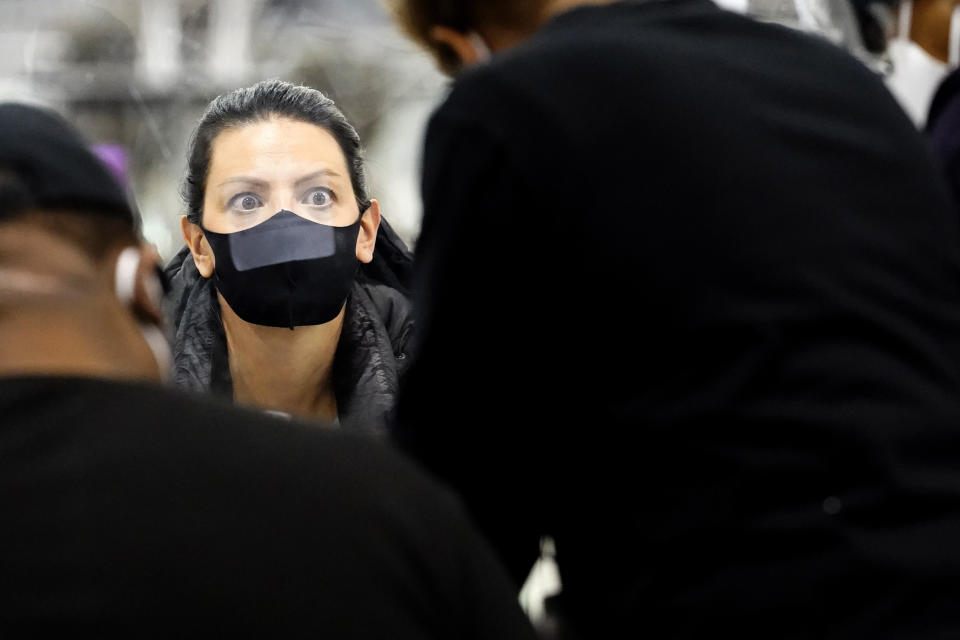 A recount observer watches ballots during a Milwaukee hand recount of Presidential votes at the Wisconsin Center, Friday, Nov. 20, 2020 in Milwaukee, Wis. The recount of the presidential election in Wisconsin’s two most heavily Democratic counties began Friday with President Donald Trump’s campaign seeking to discard tens of thousands of absentee ballots that it alleged should not have been counted. (AP Photo/Nam Y. Huh)