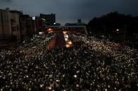 Pro-democracy activists wave mobile phones with lights during a demonstration at Kaset intersection, suburbs of Bangkok, Thailand, Monday, Oct. 19, 2020. Thai authorities worked Monday to stem a growing tide of protests calling for the prime minister to resign by threatening to censor news coverage, raiding a publishing house and attempting to block the Telegram messaging app used by demonstrators. (AP Photo/Sakchai Lalit)