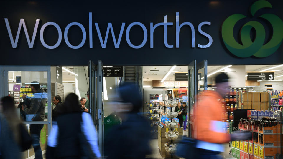 Photo shows people walking past a busy Woolworths store. Source: AAP