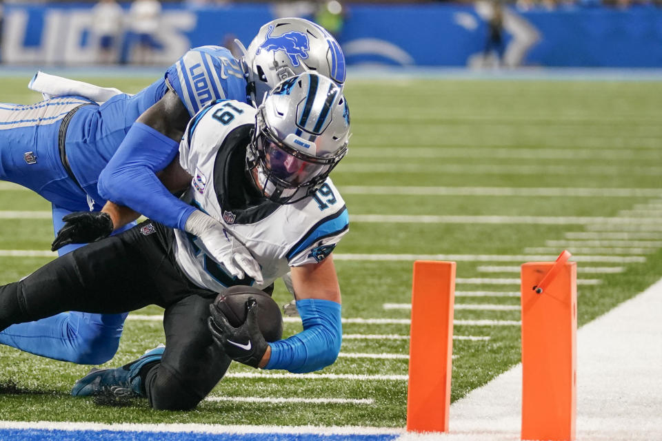 Carolina Panthers wide receiver Adam Thielen (19) scores a touchdown as Detroit Lions safety Tracy Walker III (21) tries to tackle in the second half of an NFL football game in Detroit, Sunday, Oct. 8, 2023. The Lions won 42-24. (AP Photo/Paul Sancya)