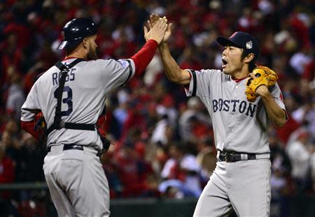 Oct 28, 2013; St. Louis, MO, USA; Boston Red Sox relief pitcher Koji Uehara (right) celebrates with catcher David Ross (3) after game five of the MLB baseball World Series against the St. Louis Cardinals at Busch Stadium. REUTERS
