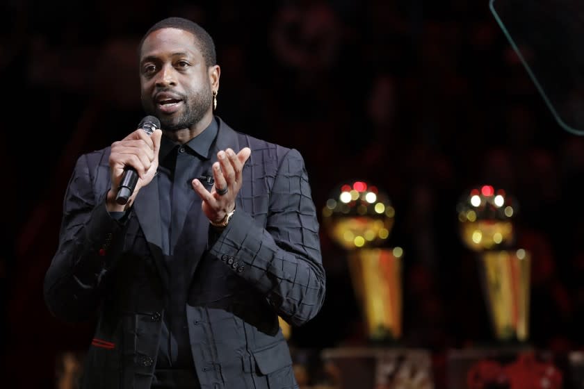 Former Miami Heat guard Dwyane Wade speaks during a jersey retirement ceremony at halftime of an NBA basketball game between the Heat and the Cleveland Cavaliers, Saturday, Feb. 22, 2020, in Miami. (AP Photo/Wilfredo Lee)